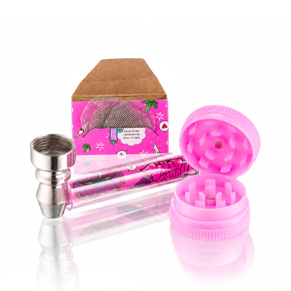 Baked Bunny Stay High pink pipe kit from Bong Warehouse with the pink grinder open beside the glass pipe and papers