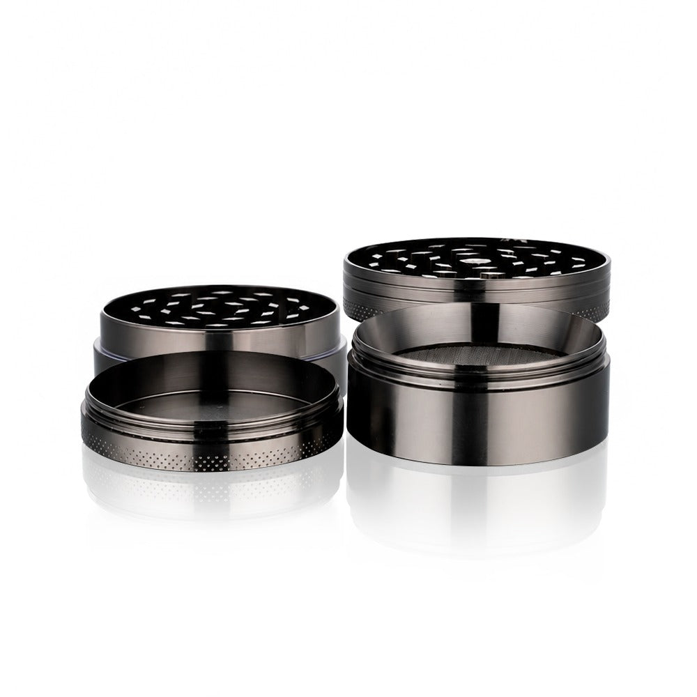 Gunmetal grey metal weed grinder from Bong Warehouse showing the perforated grinding plate and pollen catcher