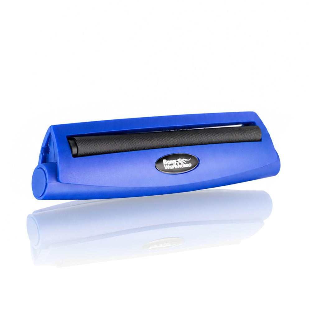 Blue king size 110mm plastic cigarette rolling machine from Bong Warehouse, low angled view of the closed machine and oval logo badge