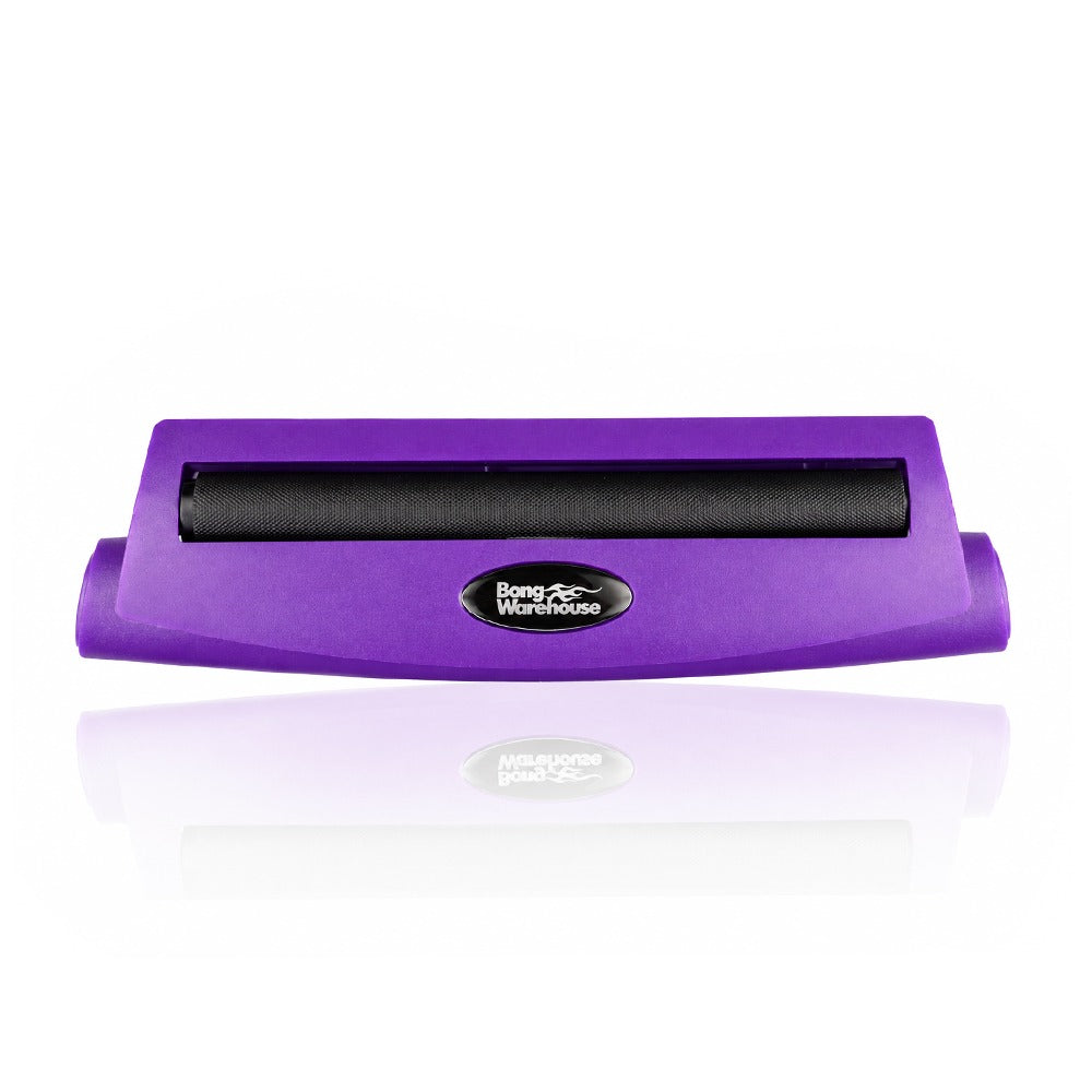 Purple king size 110mm plastic cigarette rolling machine from Bong Warehouse, front view with the black rolling apron and Bong Warehouse badge