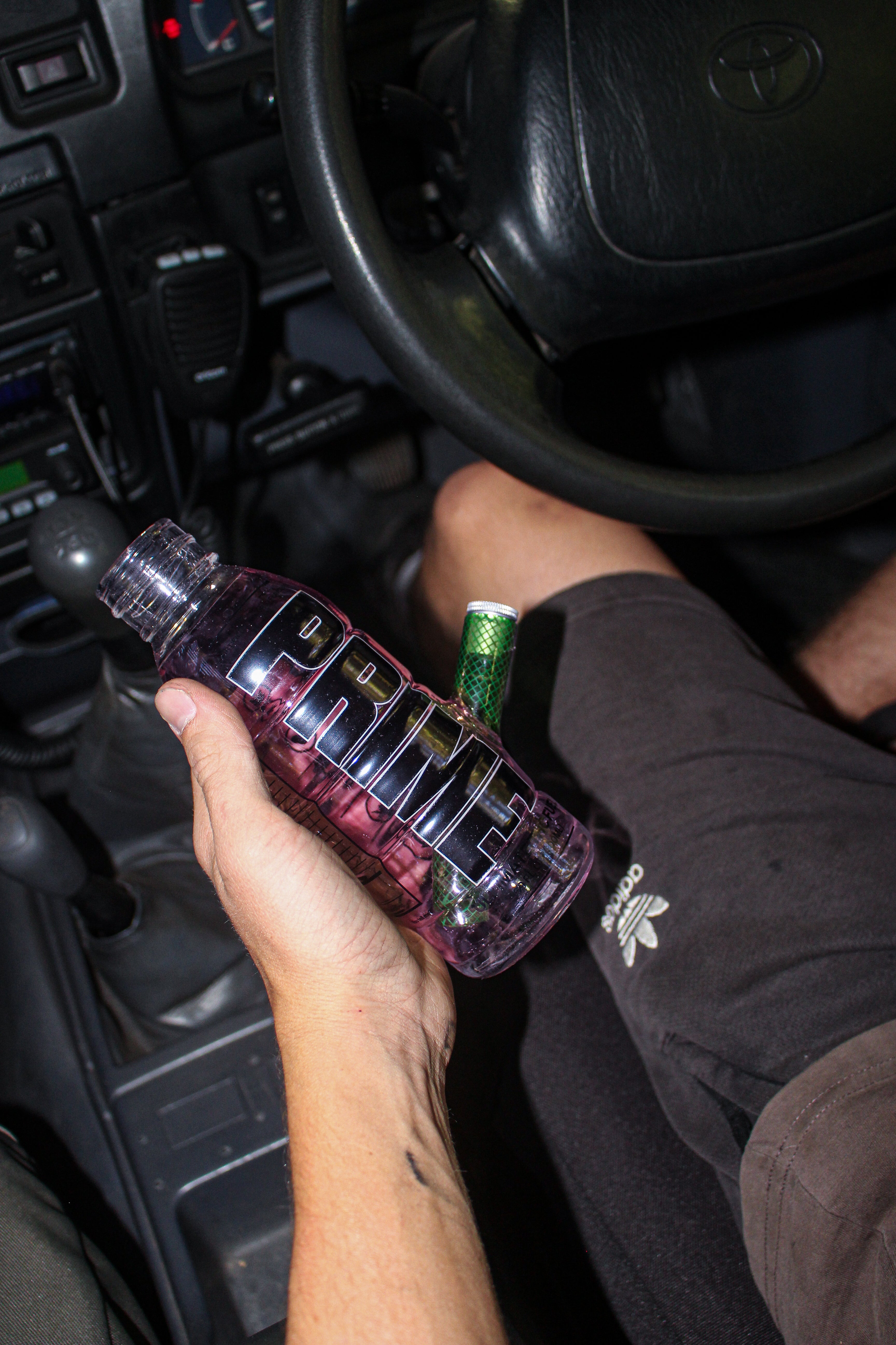 Prime Glass Bong Being Held Inside a Car - Lifestyle Photo | Bong Warehouse