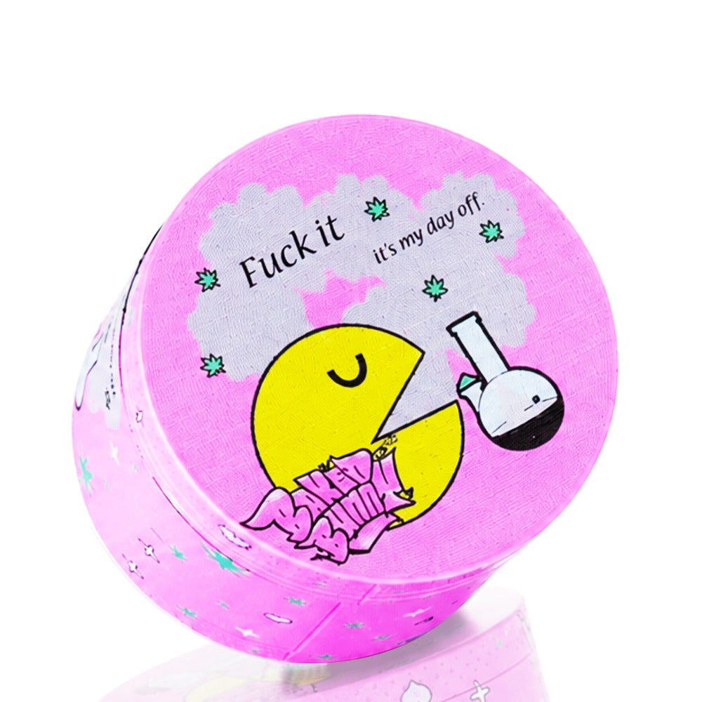 Side view of Baked Bunny Day Off pink metal grinder – smiley Pac-Man bong character, retro pop culture herb grinder, cute cheeky stoner accessory, pastel pink gift