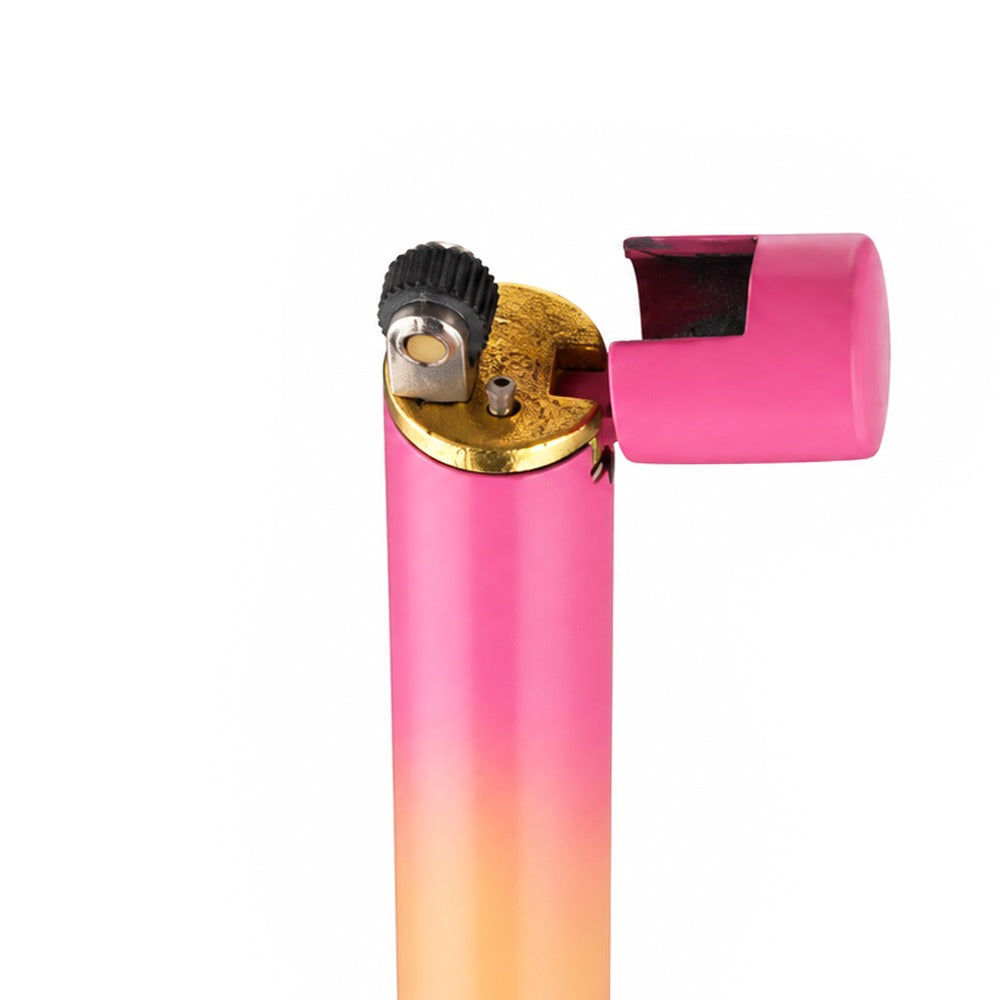 Close-up of the flint wheel and butane nozzle on a pink and peach mini metal lighter | Bong Warehouse