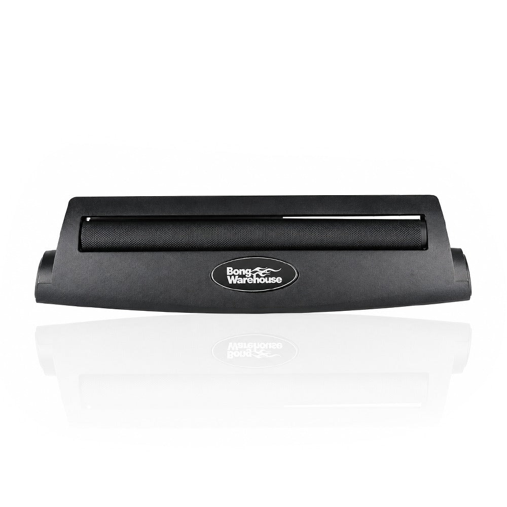 Black king size 110mm plastic cigarette rolling machine from Bong Warehouse, front view with the black rolling apron and Bong Warehouse badge