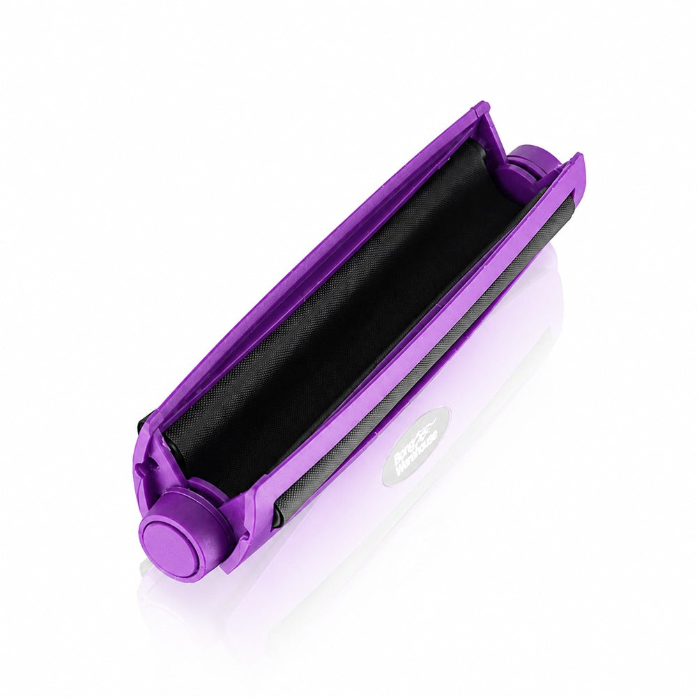 Purple king size 110mm plastic cigarette rolling machine from Bong Warehouse, open at an angle showing the twin rollers inside