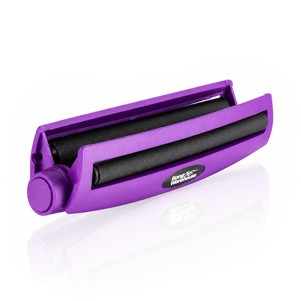 Purple king size 110mm plastic cigarette rolling machine from Bong Warehouse, shown open with the roller lid lifted and black rollers exposed