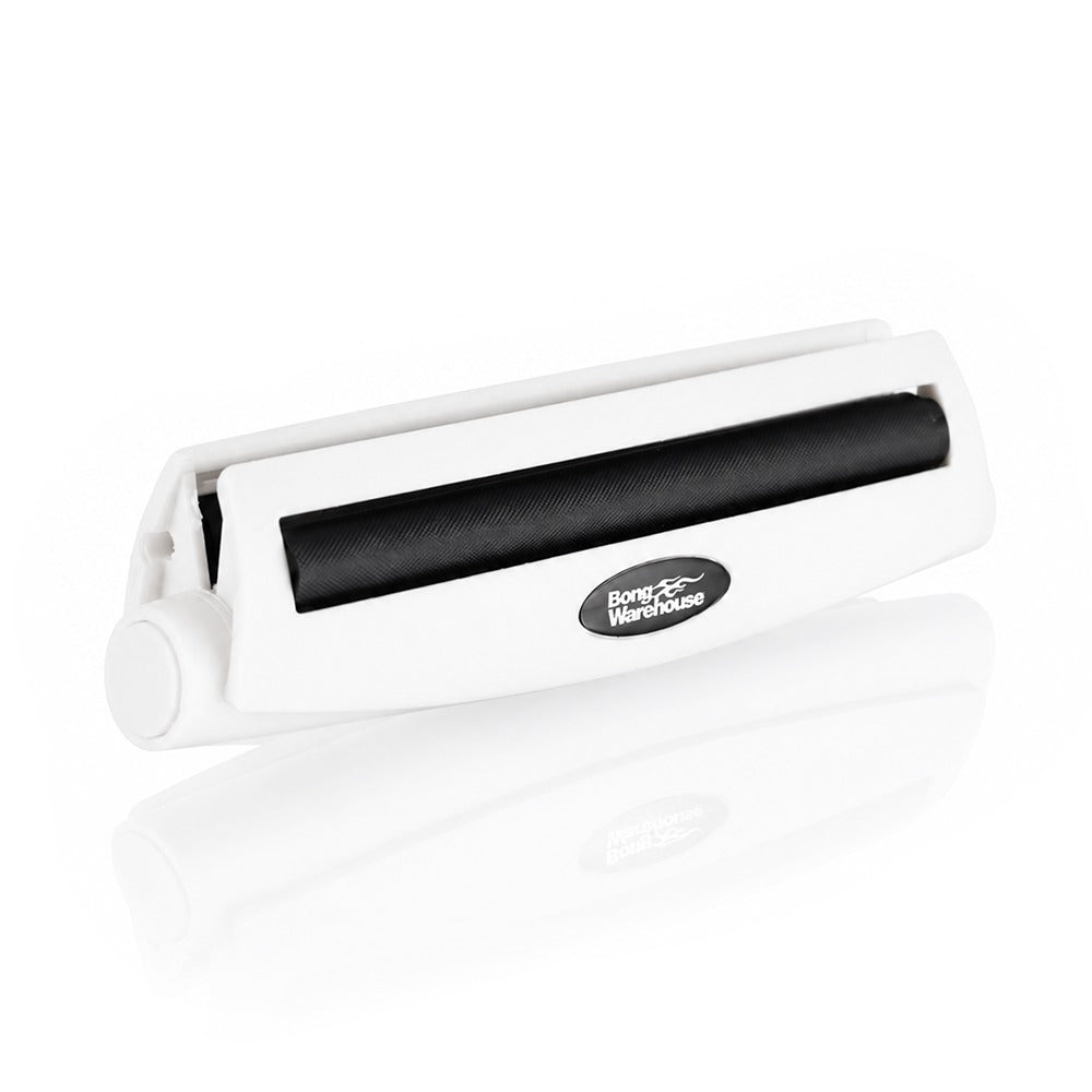 White king size 110mm plastic cigarette rolling machine from Bong Warehouse, low angled view of the closed machine and oval logo badge