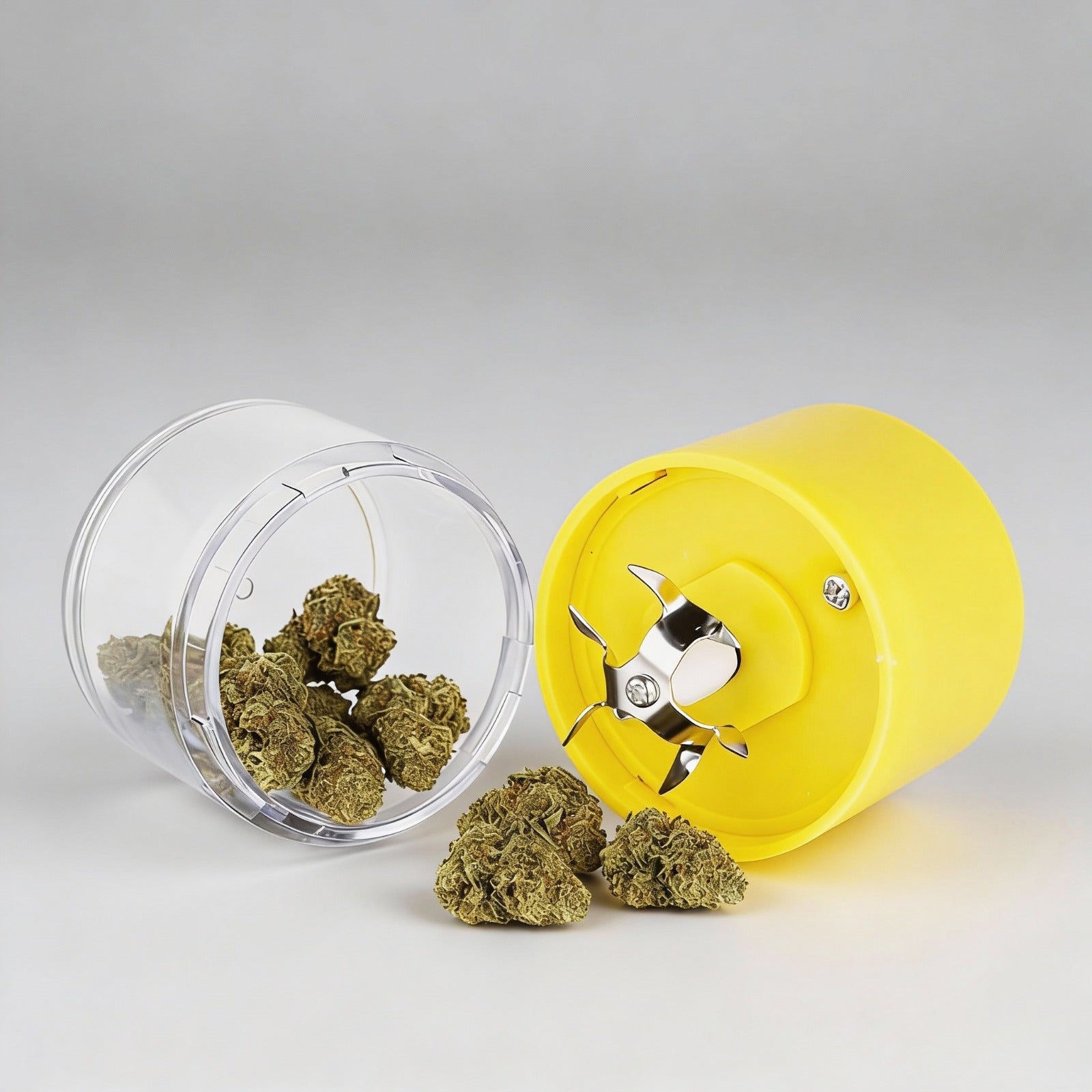 Yellow herb grinder with cannabis buds on a light gray background