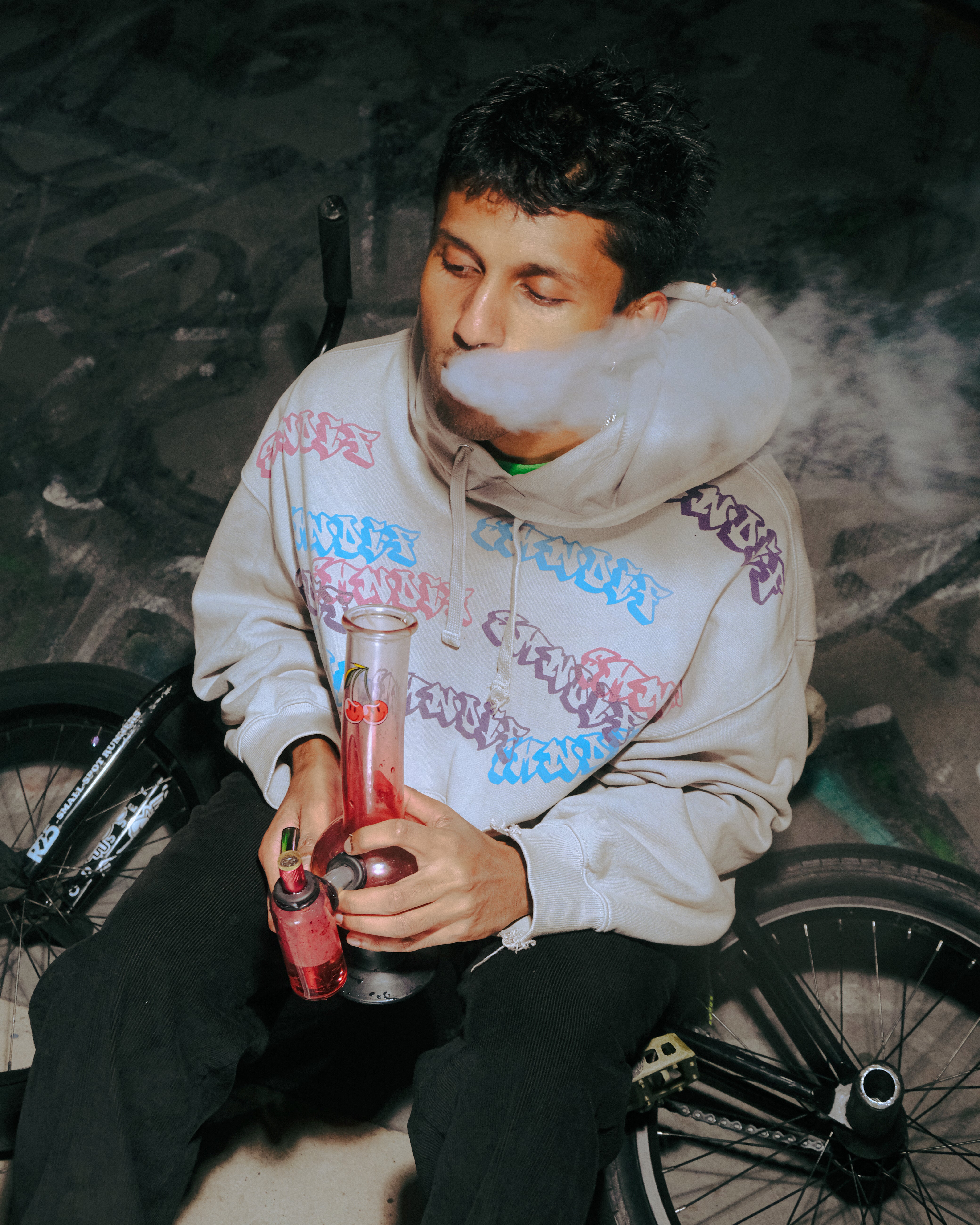 Exhaling smoke after using Bong Warehouse Double Chamber 30cm Glass Bong – Pink Cherry Bomb