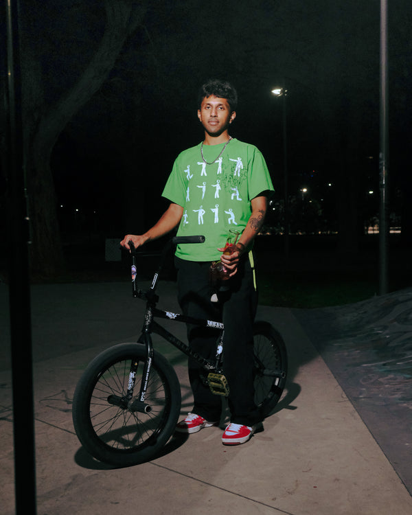 Stoner holding a Bong Warehouse Double Chamber 30cm Glass Bong – Pink Cherry Bomb with his bike