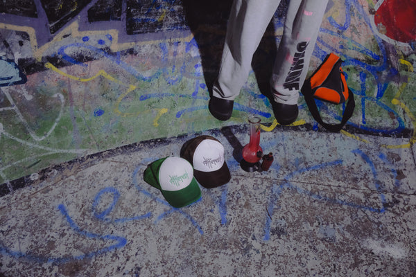 Smoking through a Bong Warehouse Double Chamber 30cm Glass Bong – Pink Cherry Bomb with friends trucker hat