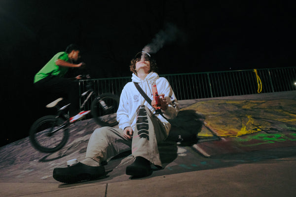 Blowing smoke into the air after using Bong Warehouse Double Chamber 30cm Glass Bong – Pink Cherry Bomb