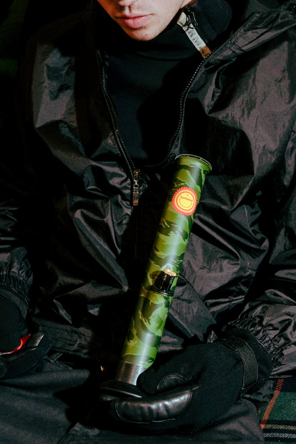 Man holding the Bong Warehouse Large Tube 33cm Glass Bong in Camo Sunbaked Pattern