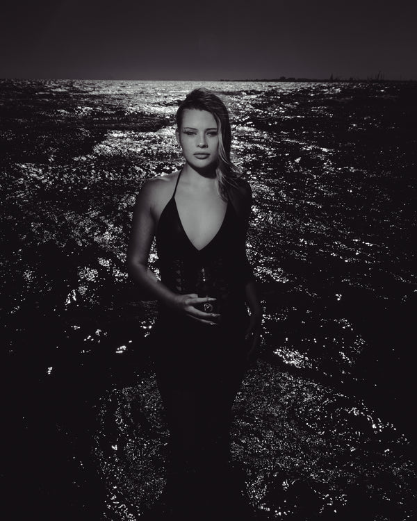 Woman standing on beach with ocean background holding Bong Warehouse Black High Tiger 17.5cm Bottle Bong
