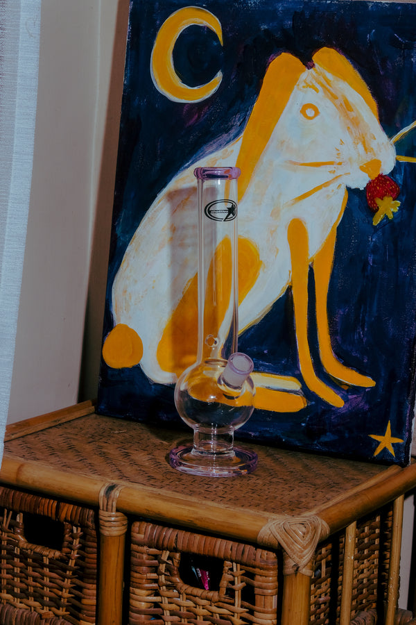 Shotties™ 33 cm Glass Bent Bubble Bong in clear and purple glass from Bong Warehouse, displayed on a drawer.