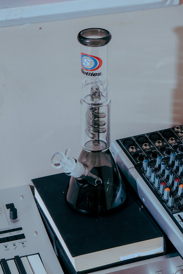 Shotties™ 30 cm Spiral Perk Glass Beaker Bong in clear smokey glass from Bong Warehouse on top oof the book