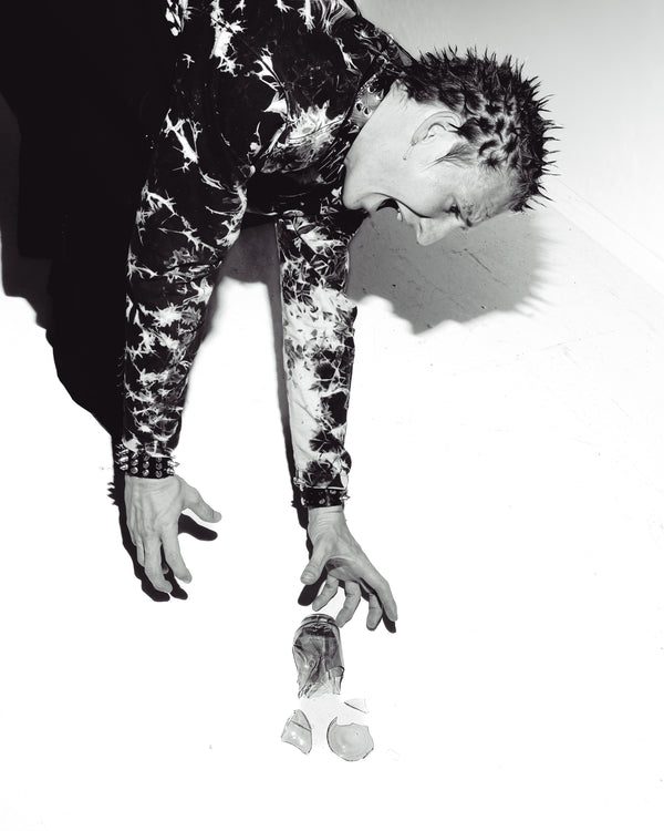A grayscale photo of a man with Bong Warehouse Mini Beaker Bong