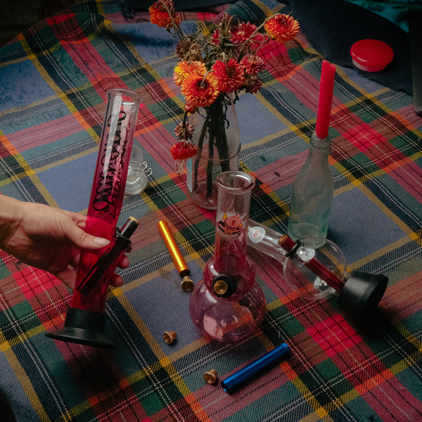 Bong Warehouse Pink Bongs collection with metal stem and cone piece on table