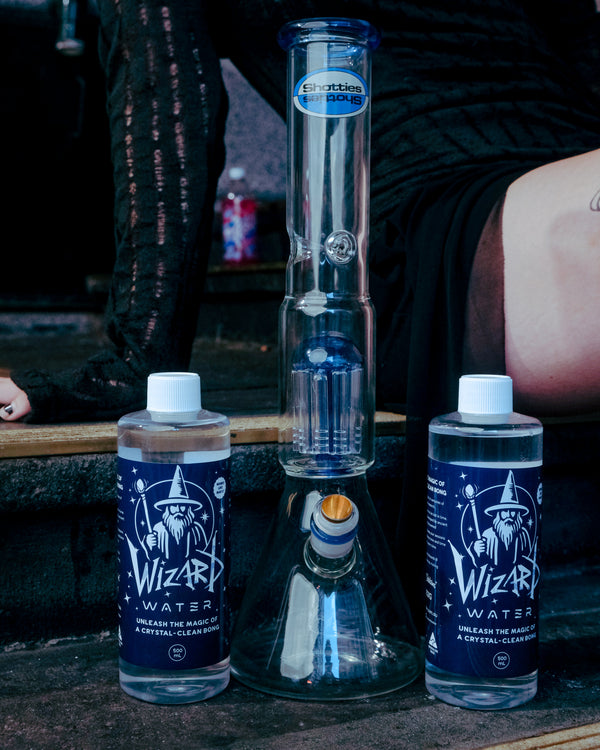 Empty Shotties™ 33 cm Glass Perc Pillar Bong in clear and blue glass from Bong Warehouse with two bottles of Wizard Water
