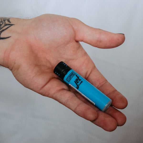 Holding a Clipper Jet Flame Lighter Large Shiny Blue from Bong Warehouse