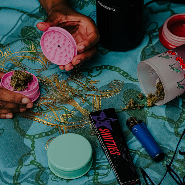 Grinding of weeds on the table with pink manual weed grinder from Bong Warehouse