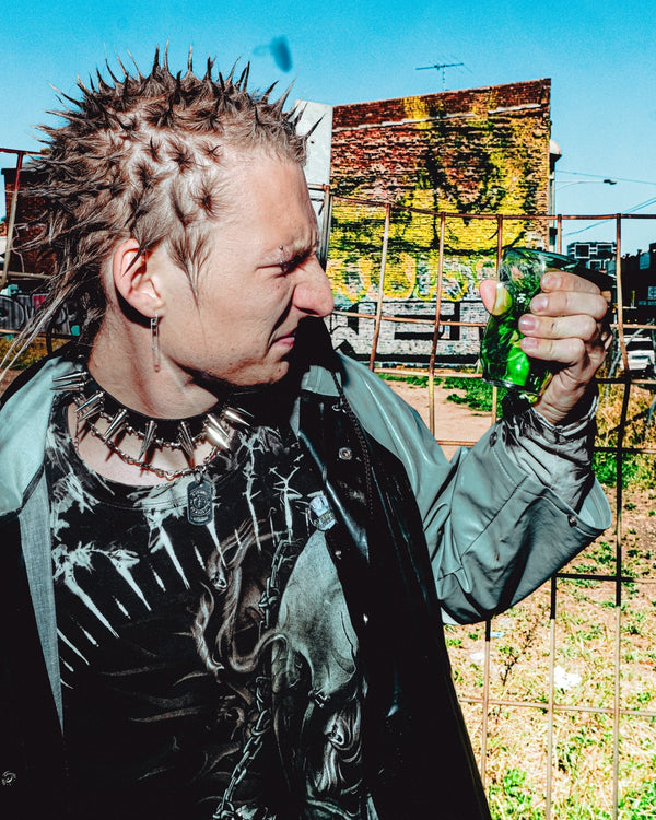 Man holding the shattered green Bong Warehouse Cute Soda Can Glass Bong in his palm.