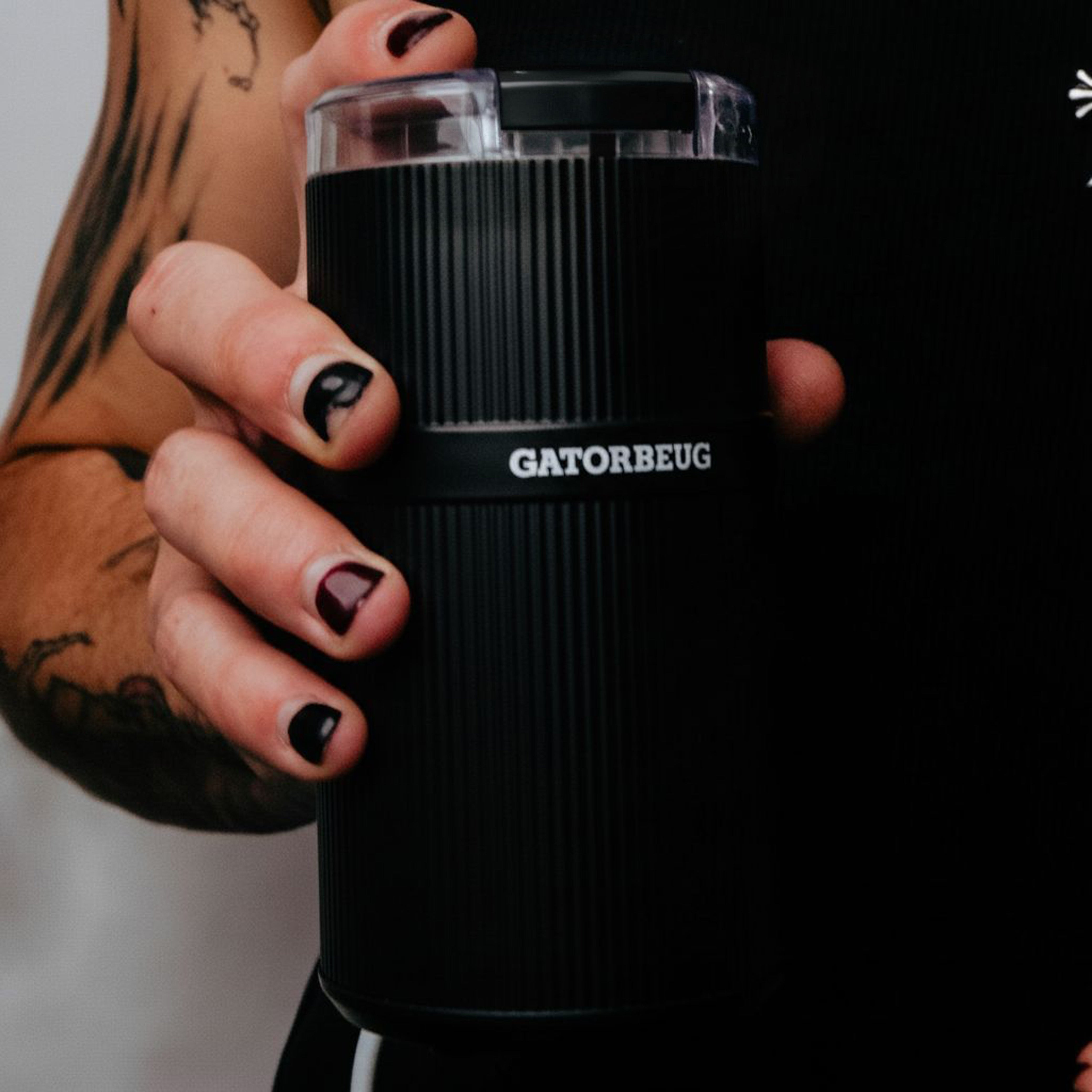 Gatorbeug Compact Electric Weed and Herb Grinder in Black held by a model 