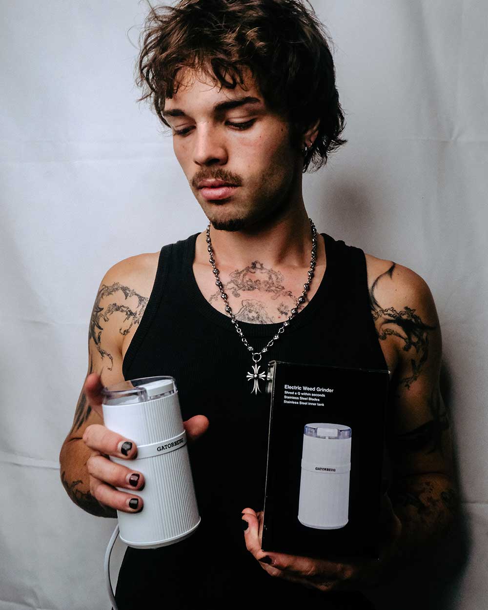 Gatorbeug Compact Electric Weed and Herb Grinder in White with Box held by a model