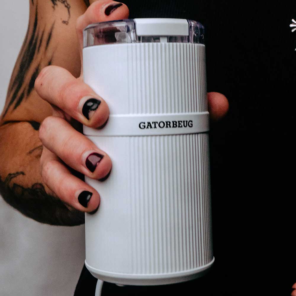Gatorbeug Compact Electric Weed and Herb Grinder - White held by model