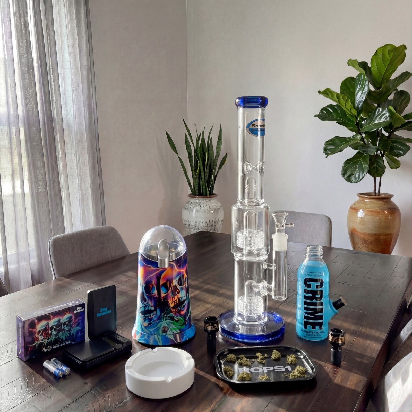Glass smoking apparatus and Kmart CoffeeGrinder Skulls on a table with plants in the background