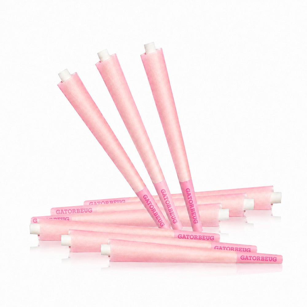 Gatorbeug King Size Pre-Rolled Cones 50 Pack – Pink, loose scattered pink cones on white background